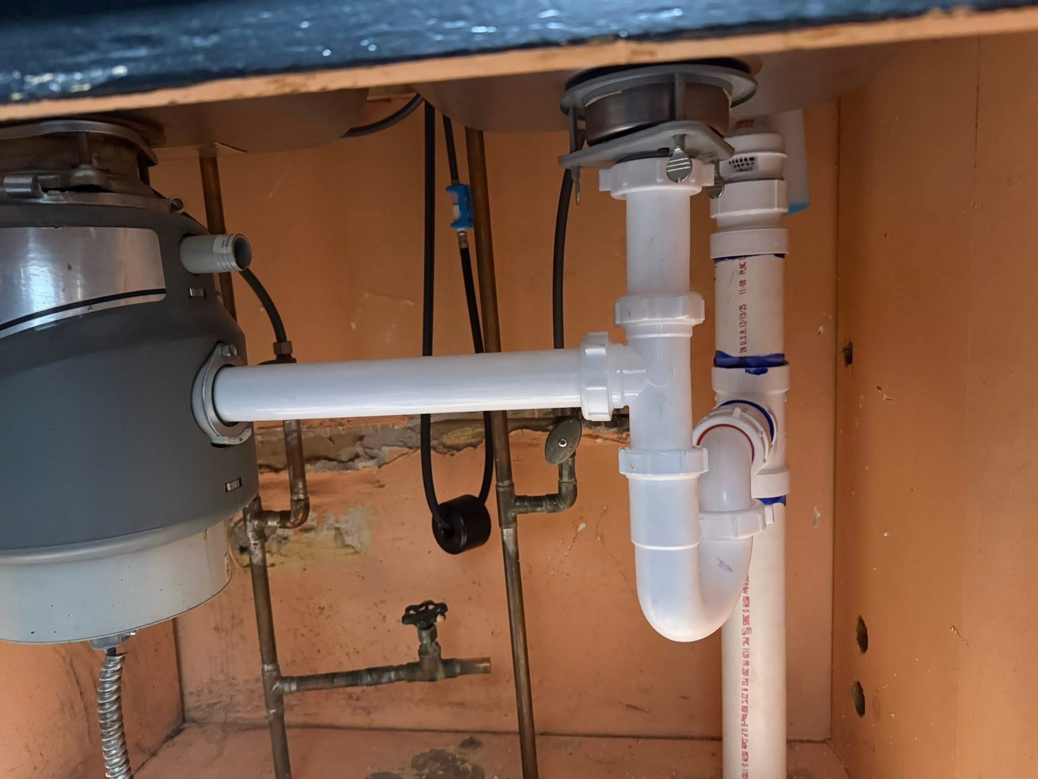 New PVC kitchen drain and garbage disposal installation