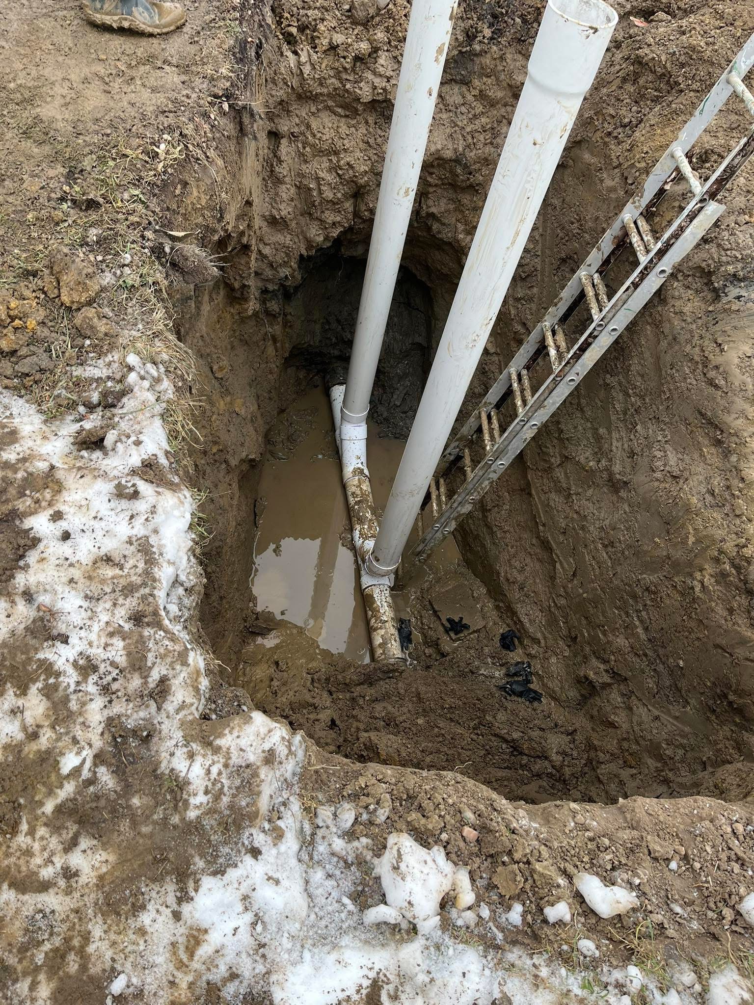 Deep sewer line excavation in winter conditions